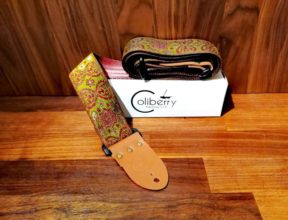 Handmade guitar straps with Baroque pattern Jaquard ribbon to the front and seatbelt backing finished with real leather ends.
