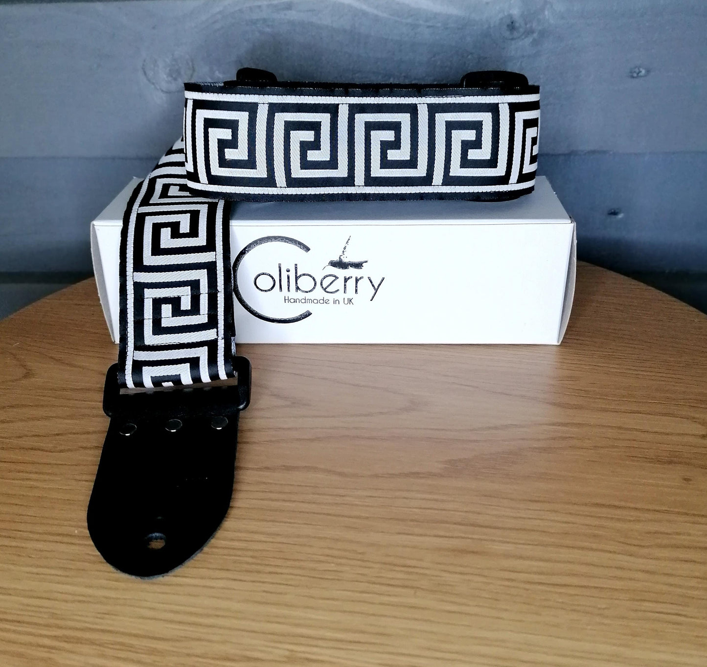 Handmade guitar strap - Greek Key Mono pattern to the front with Black Seatbelt backing and Montana Black Real Leather ends.