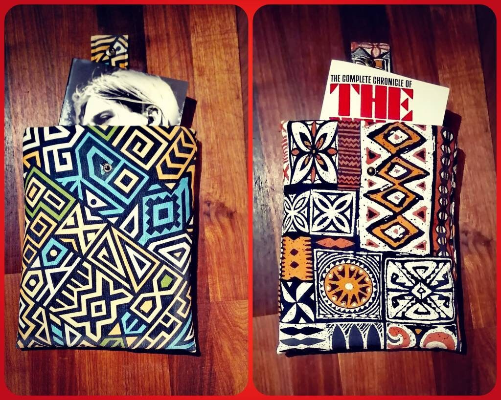 Handmade padded book sleeve/Tablet Covers, available in 2 funky patterns with snap on strap to the top.