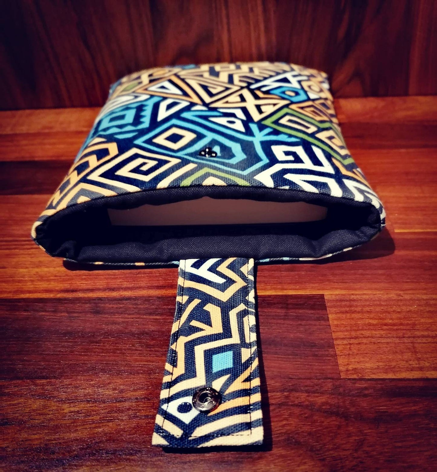 Handmade padded book sleeve/Tablet Covers, available in 2 funky patterns with snap on strap to the top.