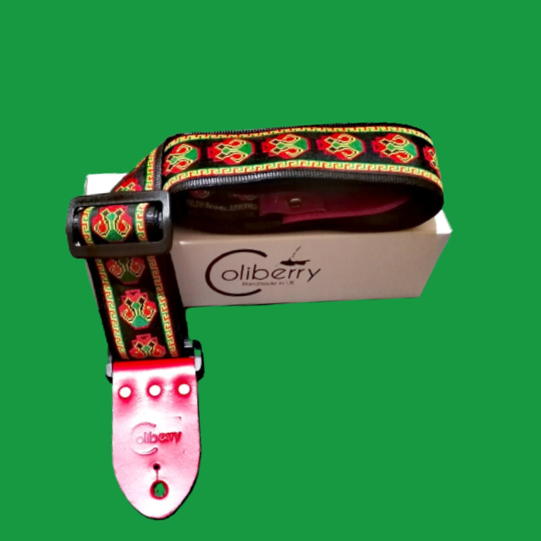 Handmade guitar strap - 'CYBER SKULL' pattern to the front with Black Seatbelt backing and Red Real Leather ends.