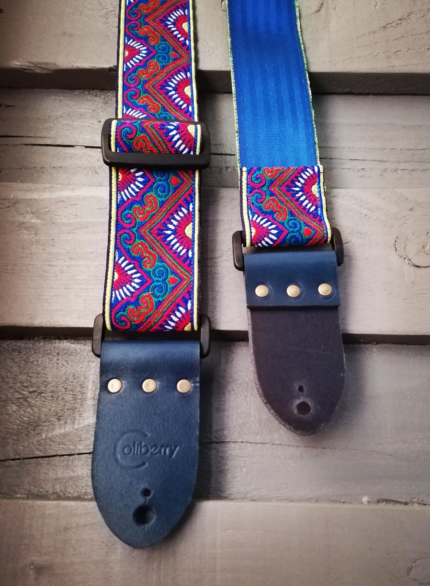 Handmade guitar strap - 'BlueTribal Horn' Blue, Red, Yellow Jaquard Ribbon with Blue Seatbelt backing and Antique Blue Real Leather ends.