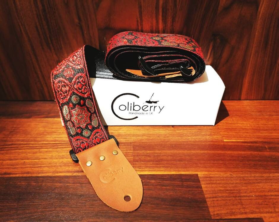 Handmade guitar straps with Baroque pattern Jaquard ribbon to the front and seatbelt backing finished with real leather ends.