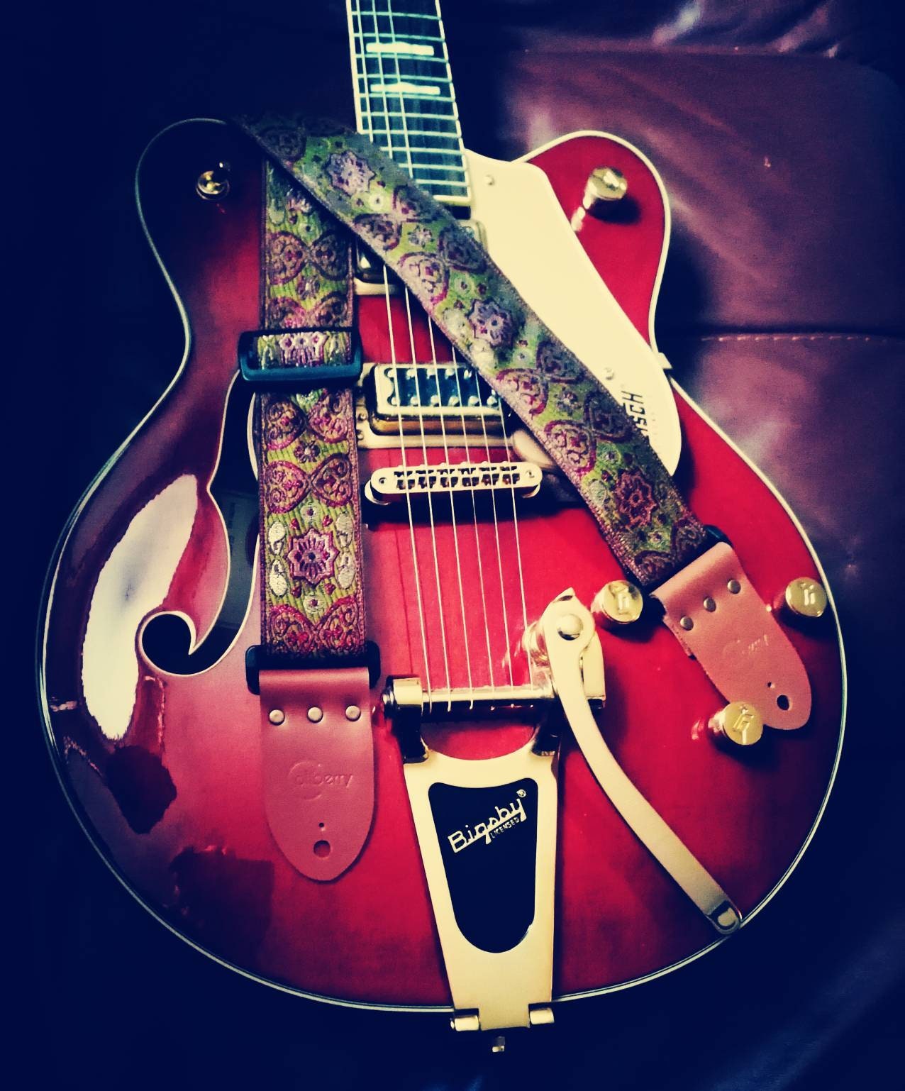 Handmade guitar straps with Baroque pattern Jaquard ribbon to the front and seatbelt backing finished with real leather ends.