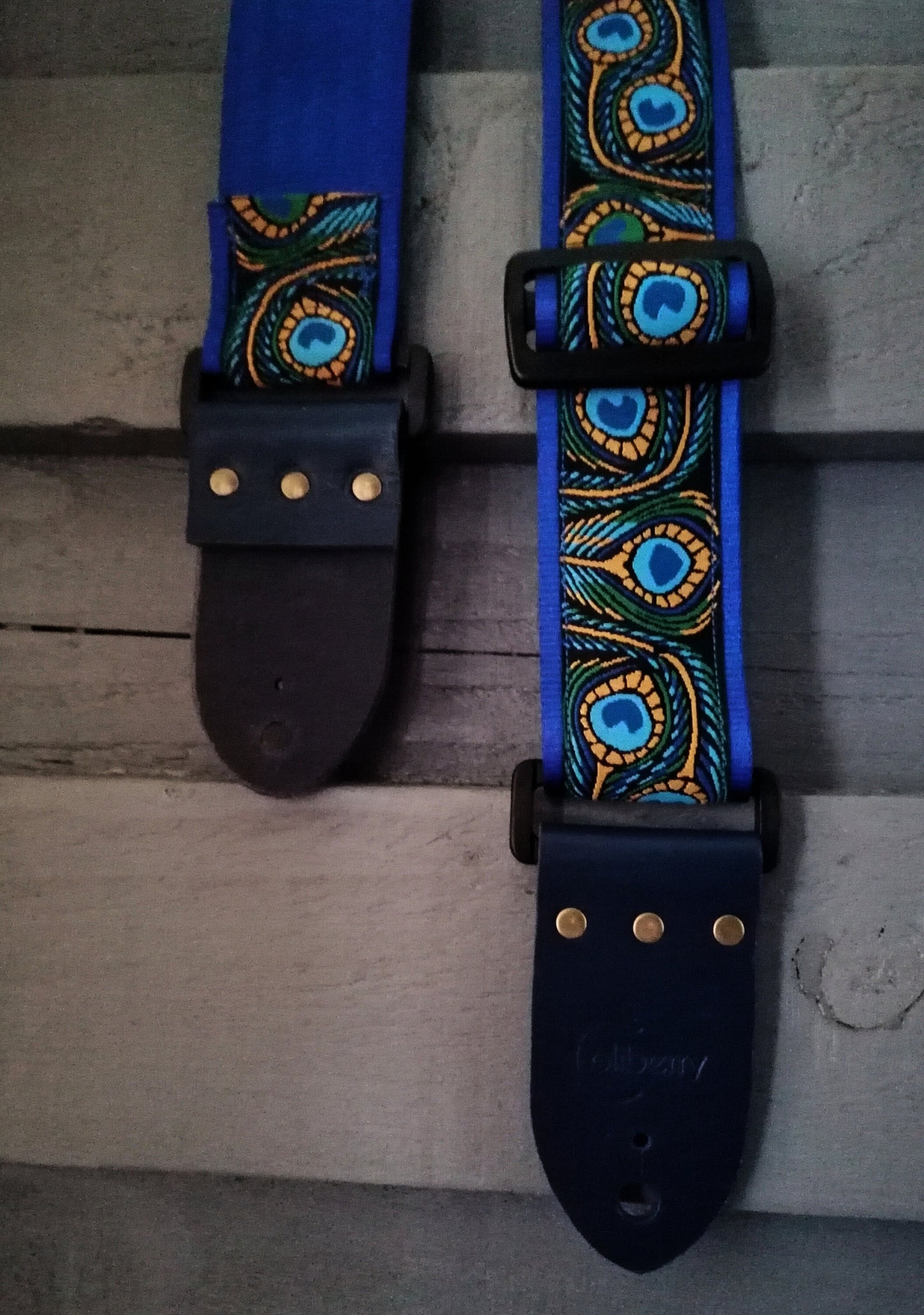 Handmade guitar strap - Blue Peacock pattern to the front with Royal Blue Seatbelt backing and Midnight Blue colour Real Leather ends