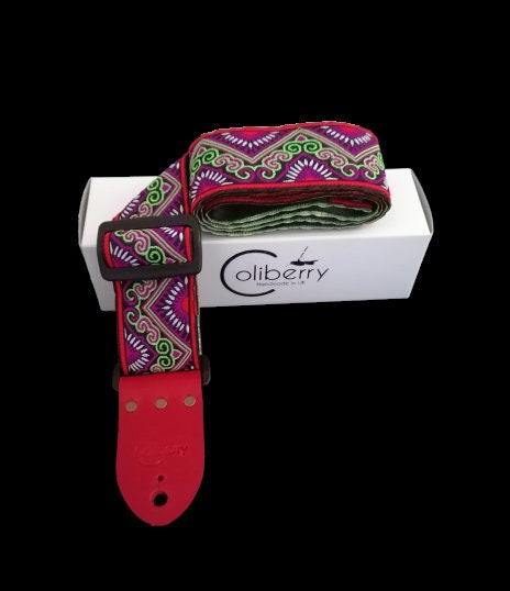 Handmade guitar strap - 'Red Tribal Horn' Red and Lime Jaquard Ribbon with Black Seatbelt backing and Antique Red Real Leather ends.