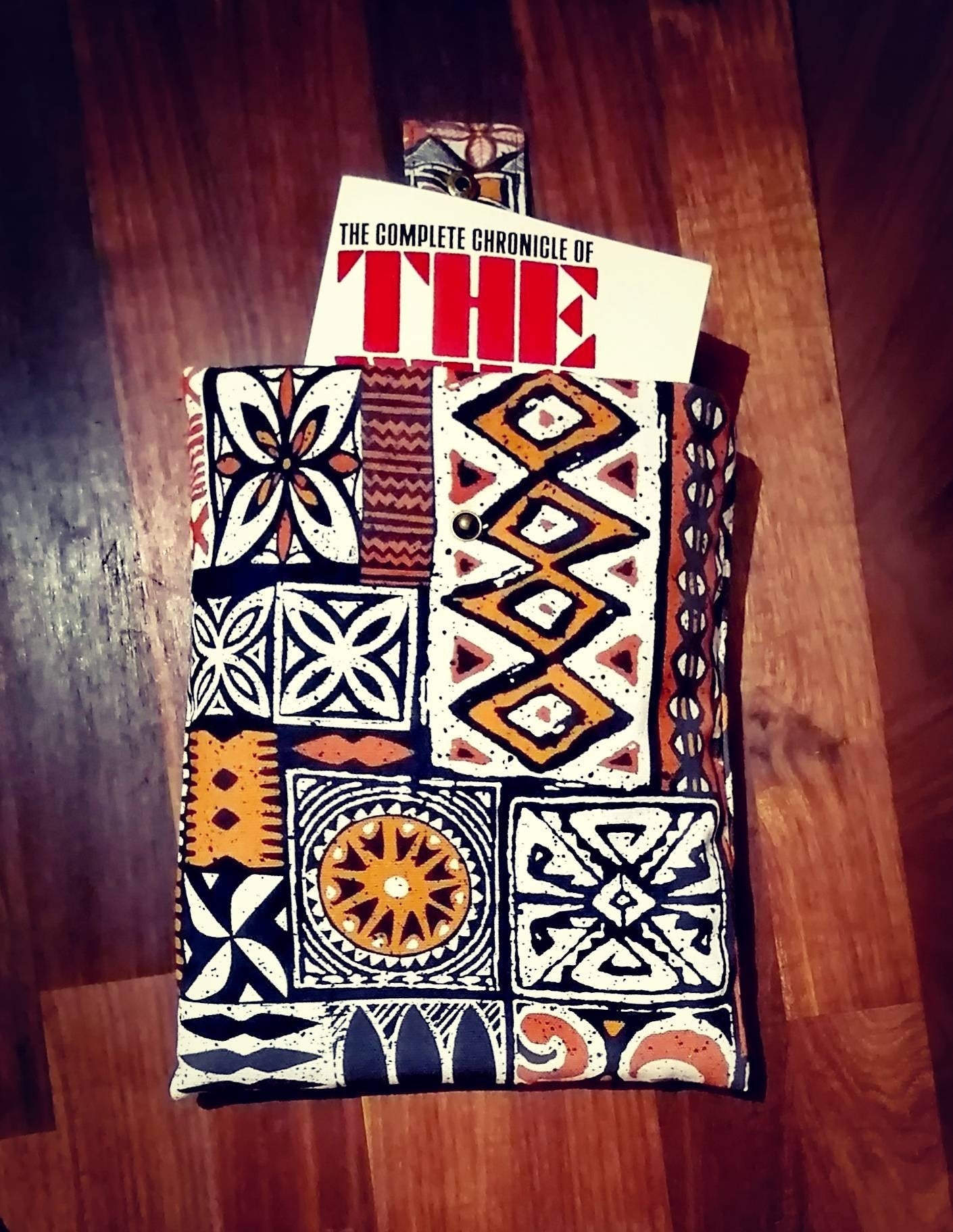 Handmade padded book sleeve/Tablet Covers, available in 2 funky patterns with snap on strap to the top.