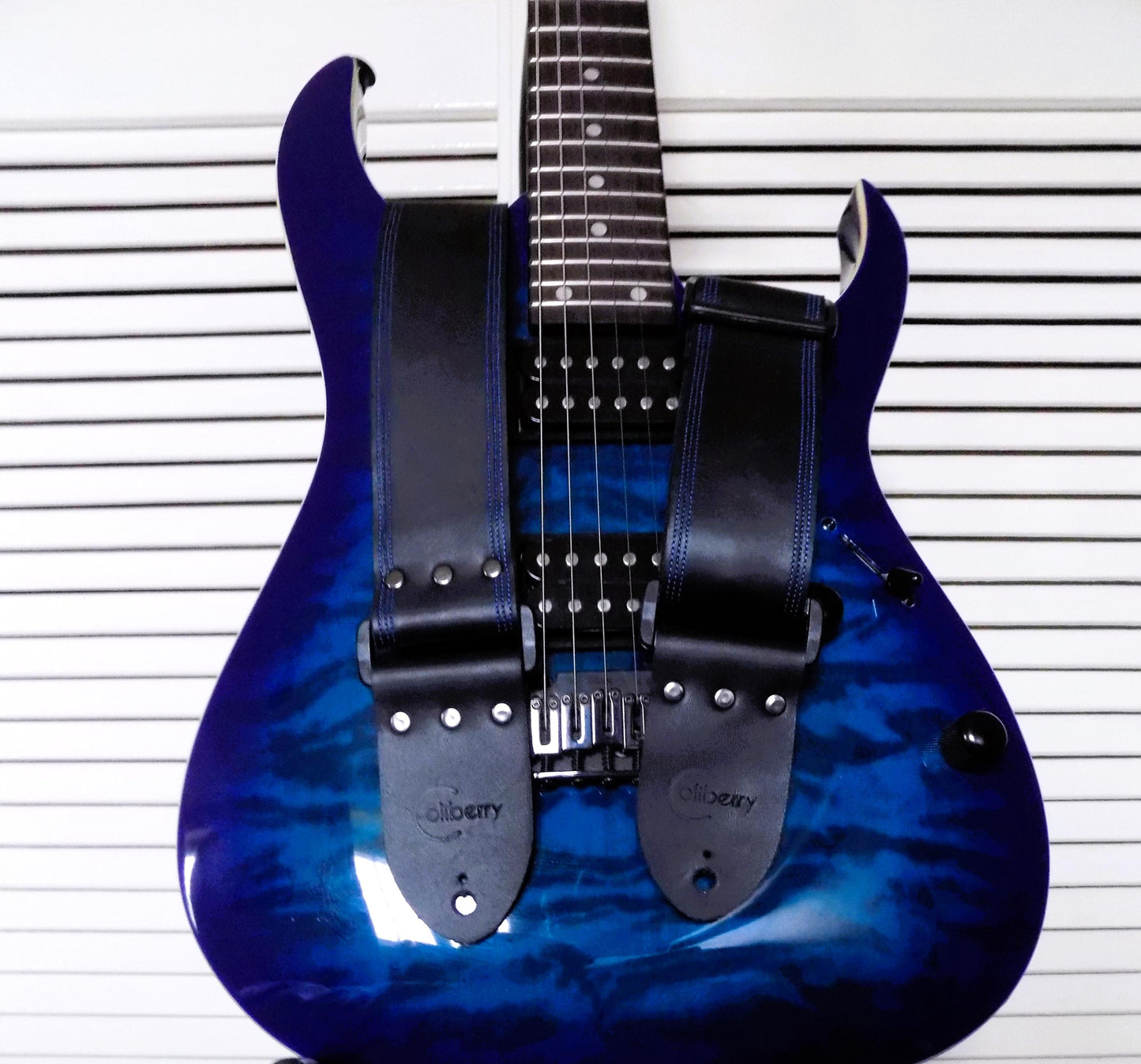 Handmade Black Full Leather Guitar Strap with seatbelt backing (different color options available) and matching threads to the front.