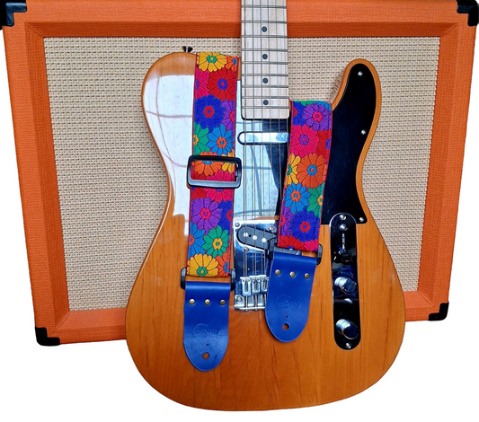 'Rainbow Meadow' Handmade Guitar Strap with blue seatbelt backing and blue real leather ends.