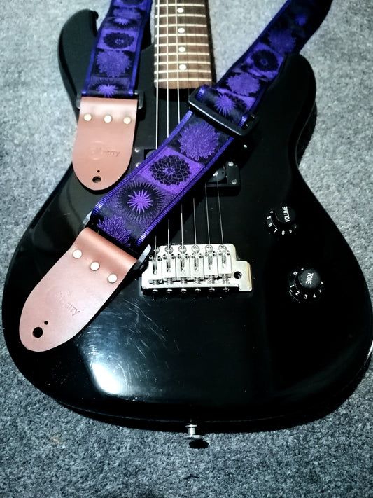 Handmade guitar strap. Flower Power available in 3 colours (Purple, Green, Red) with Seatbelt backing and Montana Hazelnut Real Leather ends