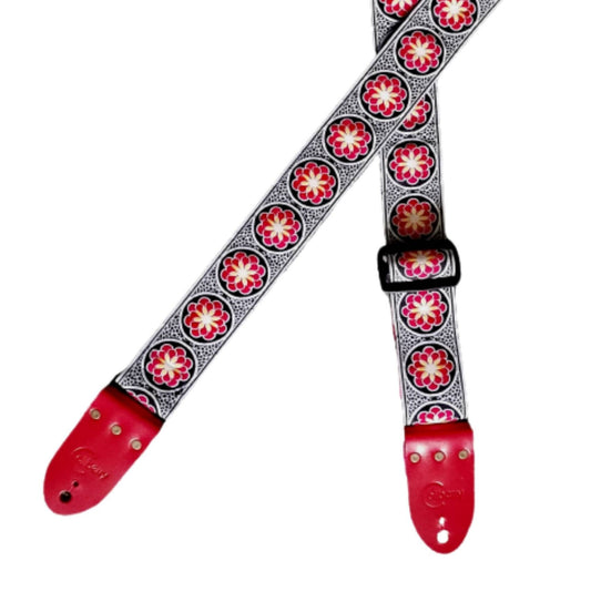 Handmade guitar strap. Red and Black embroidered flower Ribbon with Red Seatbelt backing and Red Leather ends.