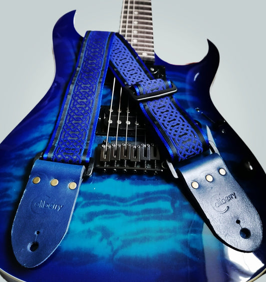 Handmade guitar strap - Blue Celtic pattern to the front with Royal Blue Seatbelt backing and Midnight Blue colour Real Leather ends.