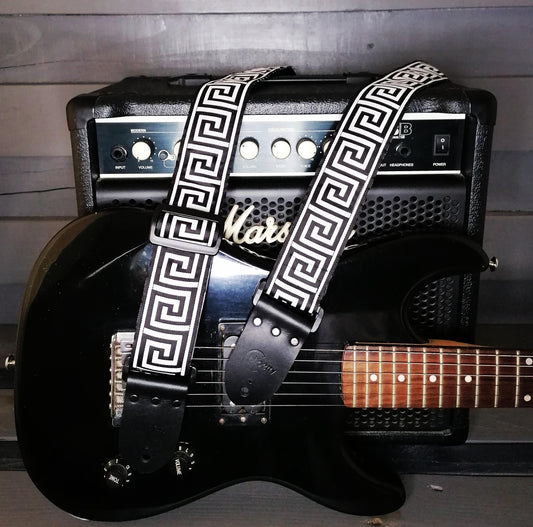 Handmade guitar strap -  Greek Key Mono pattern to the front with Black Seatbelt backing and Montana Black Real Leather ends.