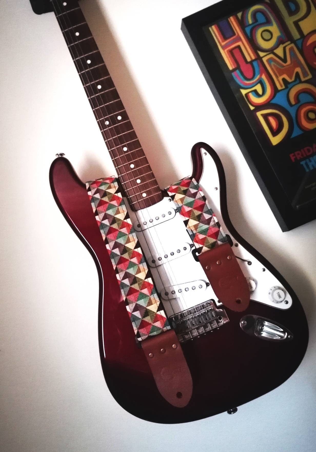 Handmade guitar strap. Multicolored 3D Squares design with black Seatbelt backing. Finished with Montana Hazelnut colour Real Leather ends.