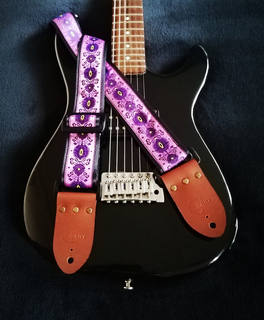 Handmade guitar strap - 'Lilac Peacock' Jaquard Ribbon on front with Black Seatbelt backing and Montana Hazelnut colour Real Leather ends.
