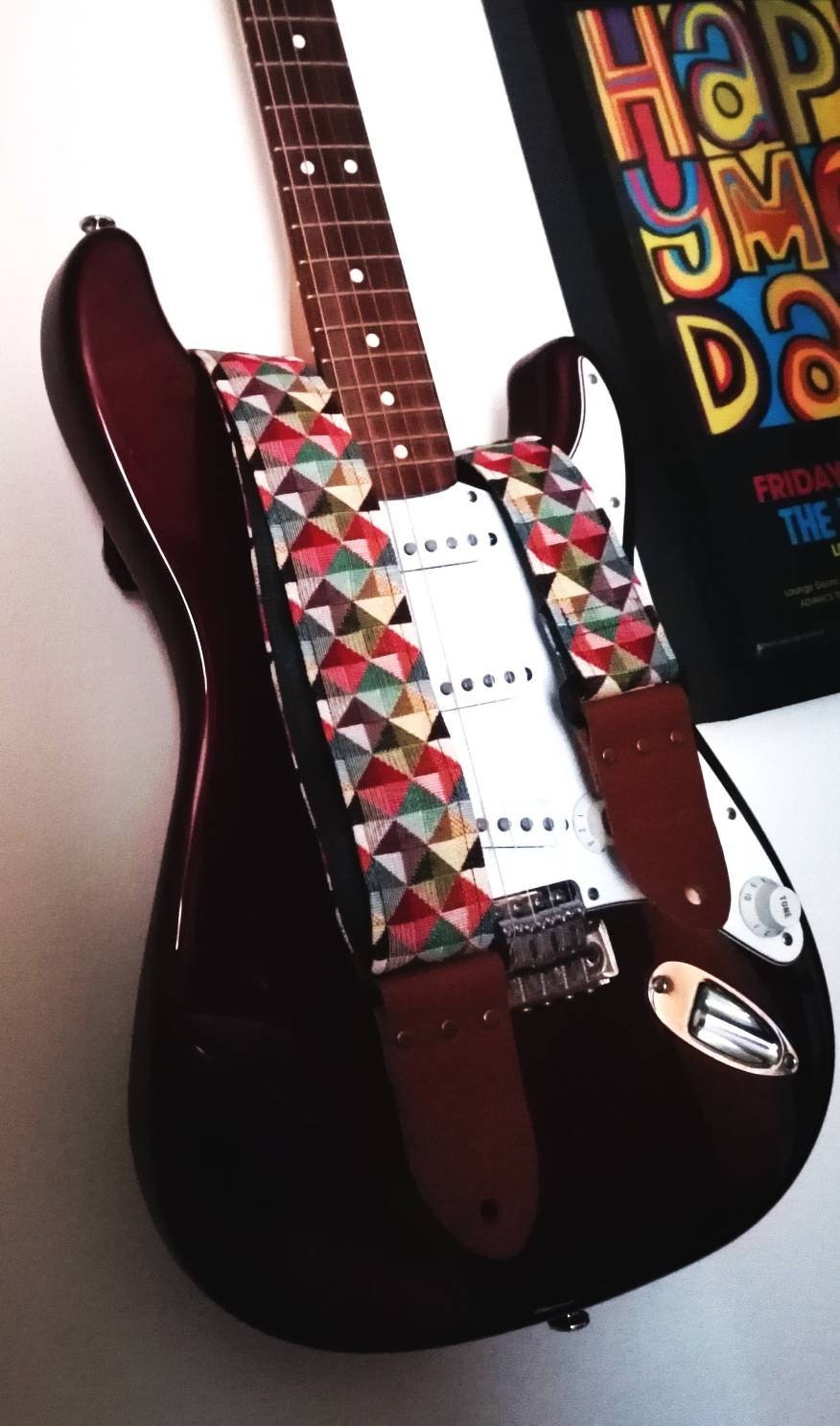 Handmade guitar strap. Multicolored 3D Squares design with black Seatbelt backing. Finished with Montana Hazelnut colour Real Leather ends.