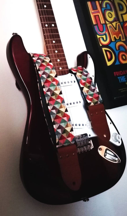 Handmade guitar strap. Multicolored 3D Squares design with black Seatbelt backing. Finished with Montana Hazelnut colour Real Leather ends.
