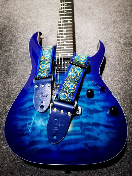 Handmade guitar strap - Blue Peacock pattern to the front with Royal Blue Seatbelt backing and Midnight Blue colour Real Leather ends