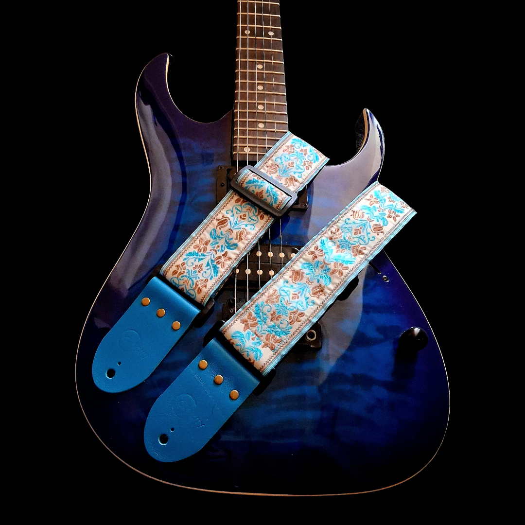 Handmade 'San Marino' guitar strap with Kingfisher Blue real leather ends. Adjustable.