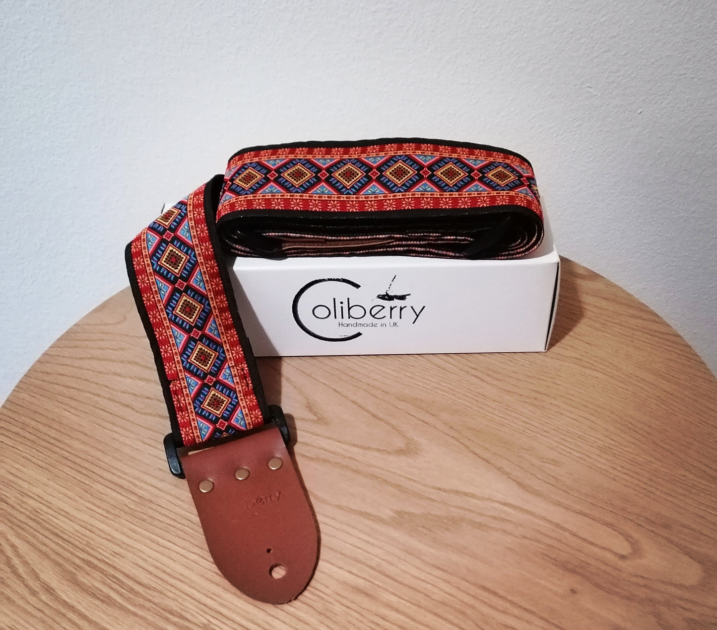 Handmade 'Rhombus' guitar strap with black seatbelt backing and Montana Hazelnut colour real leather ends.