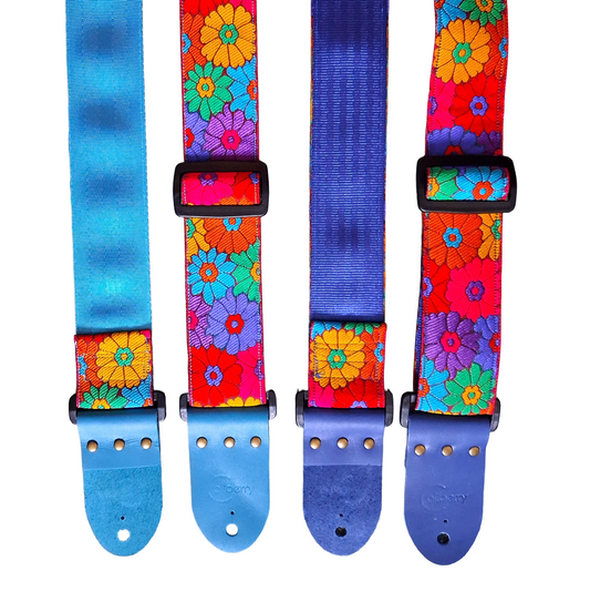 'Rainbow Meadow' Handmade Guitar Strap with blue seatbelt backing and blue real leather ends.