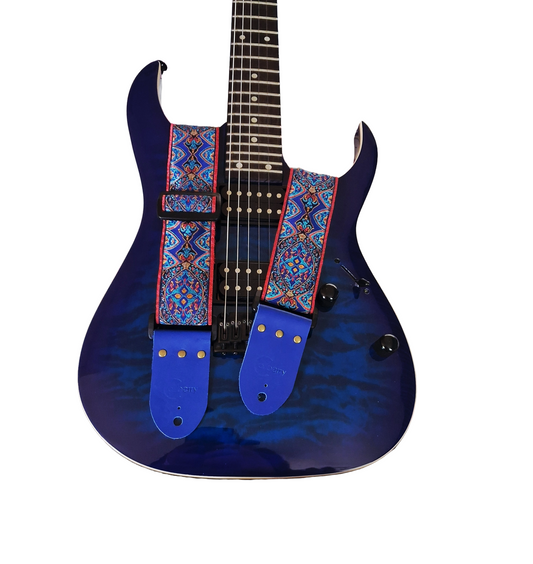 Handmade 'Blue Sunbeam' guitar strap with blue seatbelt backing and Montana Blue real leather ends.