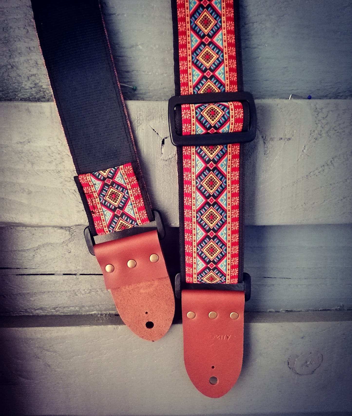 Handmade 'Rhombus' guitar strap with black seatbelt backing and Montana Hazelnut colour real leather ends.